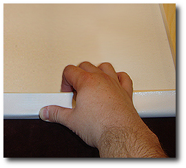 16 x 20 Canvas Stretching - Step 27 - Firmly hold canvas in position with thumb